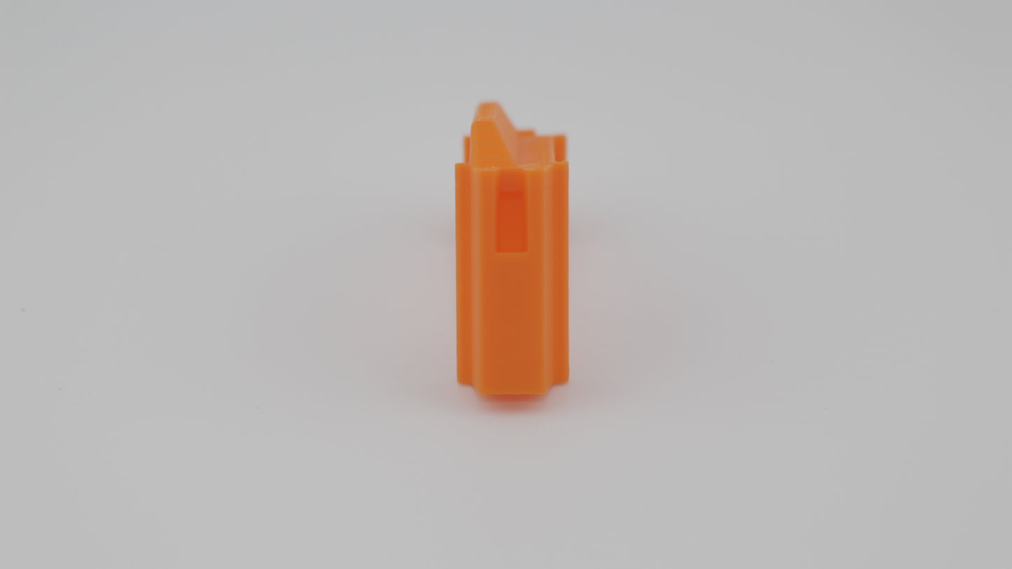 Front view of orange 3D-printed 6.5 mm Grendel magazine follower standing upright, showing ridged front profile and feed lip cutout, displayed on a light grey background.