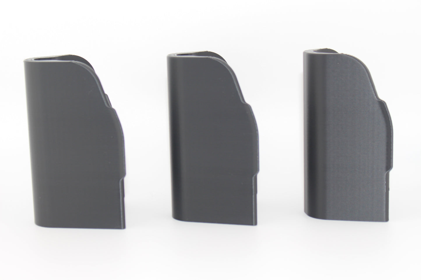 Side view of three SBA5 cheek riser inserts in 10mm, 17mm and 20mm heights showing curved outer profiles on white background