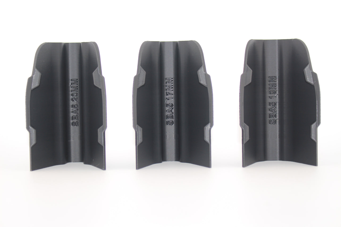 Three black SBA5 cheek riser inserts in 10mm, 17mm and 20mm heights displayed upright from bottom view on white background