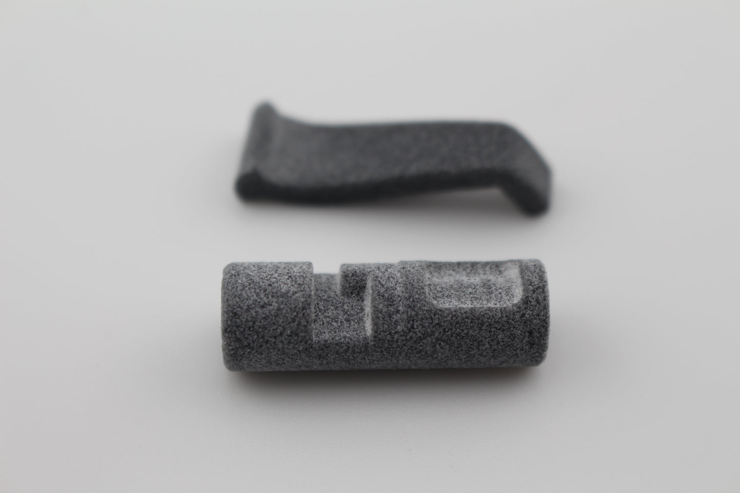 MJF 3D-printed grip and cylindrical pad components for Hoffman Tactical 3-position super safety on light grey background