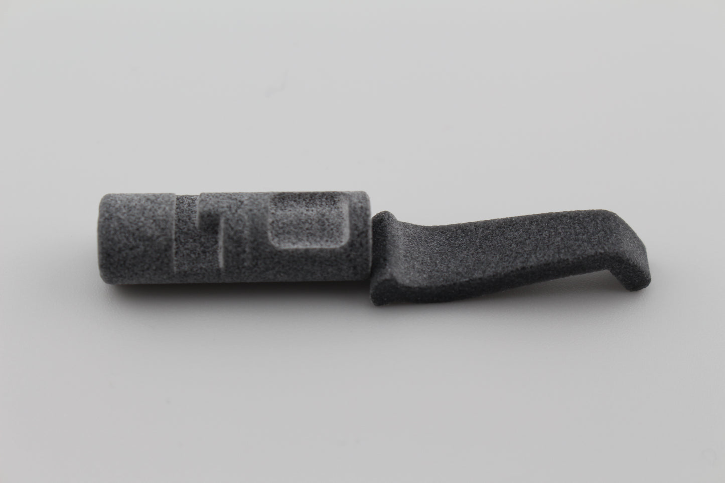 MJF 3D ‑printed cylindrical and curved lever component for Hoffman Tactical 3 ‑position super safety displayed on gray background