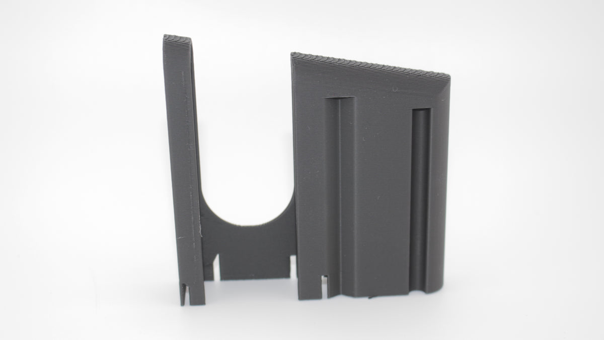 Alternate side view of gray metal K31/K11 Schmidt Rubin 7.5x55 stripper clip showing grooved side and curved cutout, displayed on white background