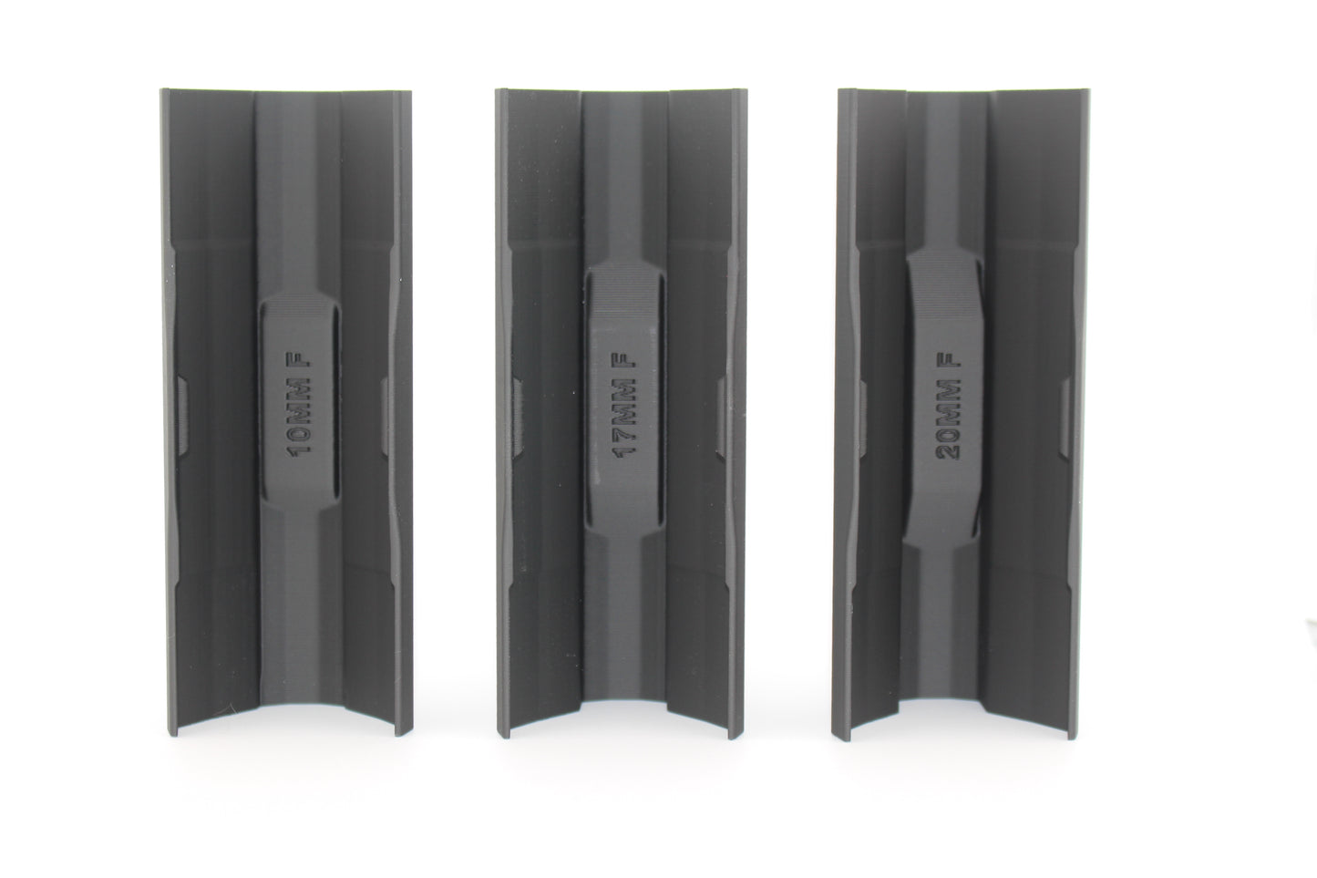 Three black full‑size SBA3 cheek riser inserts in 10mm, 17mm and 20mm heights displayed upright from bottom view on white background