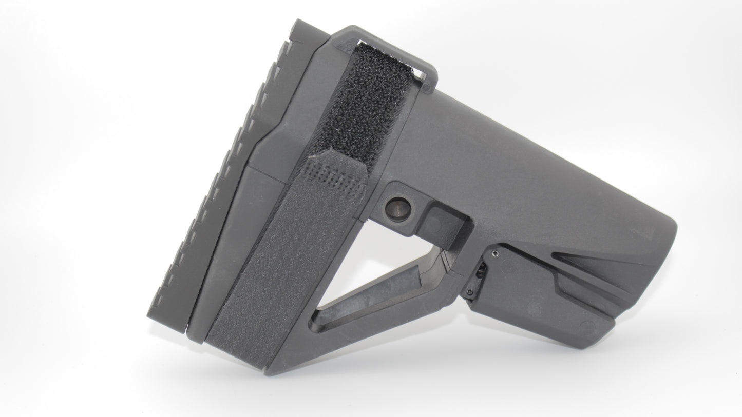 Side view of SBA5 brace with black full-length Devoid plug engaged, showing the contoured side profile of the plug and velcro strap on the brace, on a light grey background.