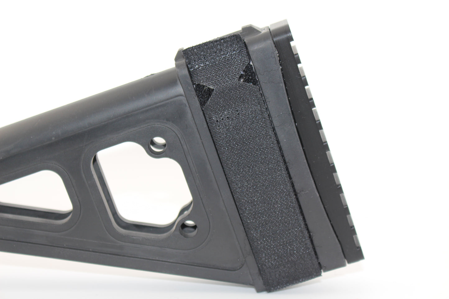 Side view of Cicada Research SB Tactical SBT full-length Devoid plug featuring black brace insert on white background