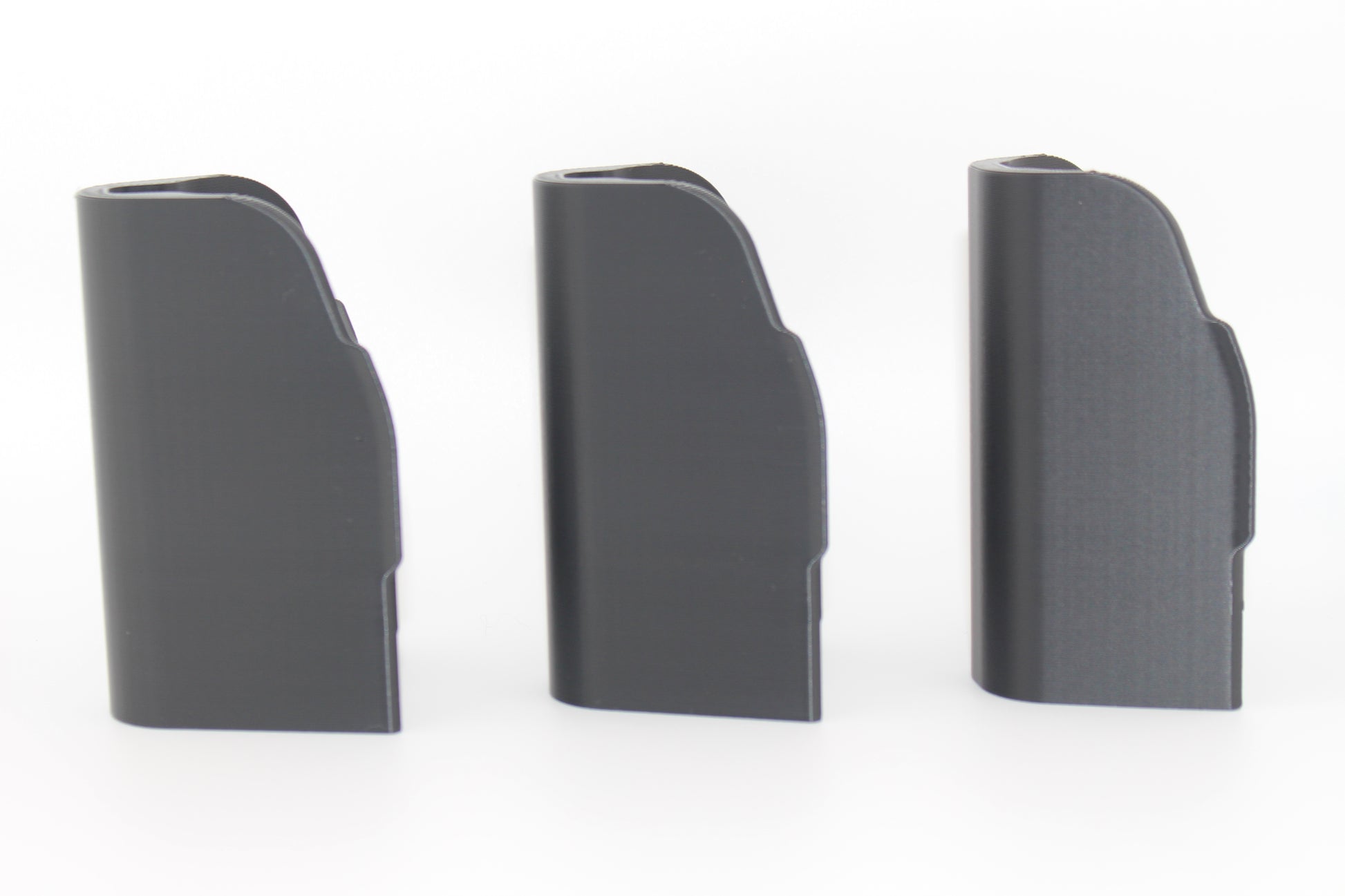 Side view of three SBA5 cheek riser inserts in 10mm, 17mm and 20mm heights showing curved outer profiles on white background
