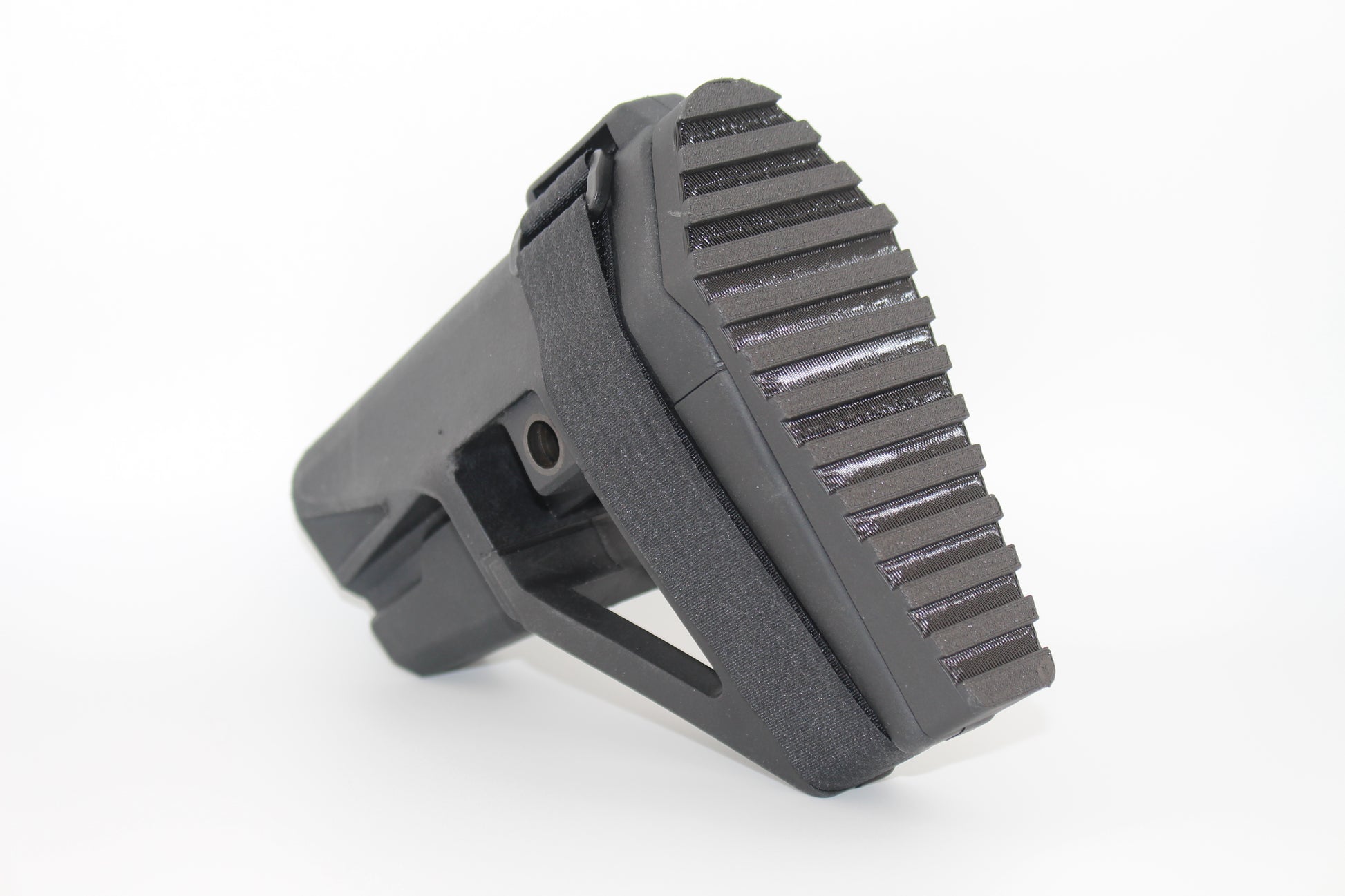 Angled view of black SBA5 full-length Devoid plug installed in the SBA5 brace, showing textured grip surface and integrated SB logo clip retention mechanism, on a light grey background.