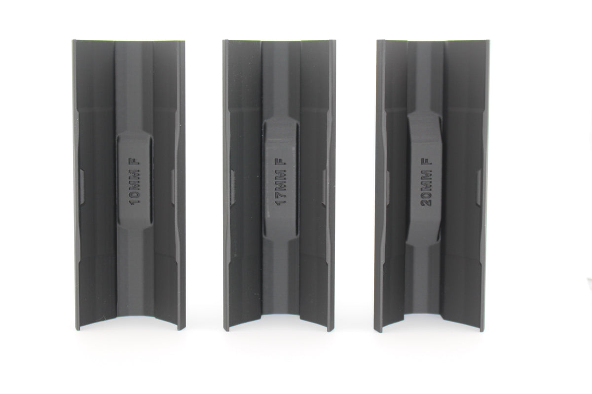 Three black full‑size SBA3 cheek riser inserts in 10mm, 17mm and 20mm heights displayed upright from bottom view on white background