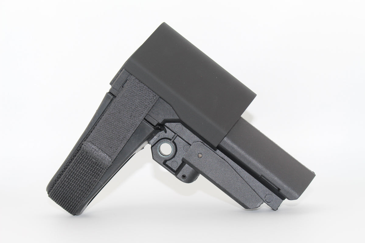 Side view of black half-size SBA3 cheek riser attached to the SBA3 brace, showing contoured riser shape and Velcro strap, displayed on a white background.