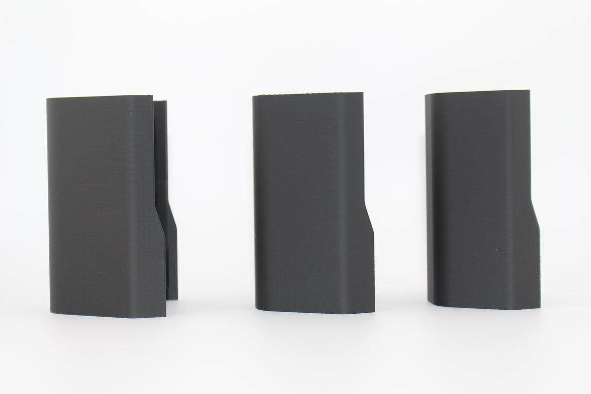 Side view of three black half-size SBA3 cheek riser inserts representing 20mm, 17mm and 10mm heights, aligned upright with contoured outer profiles, displayed on a white background.