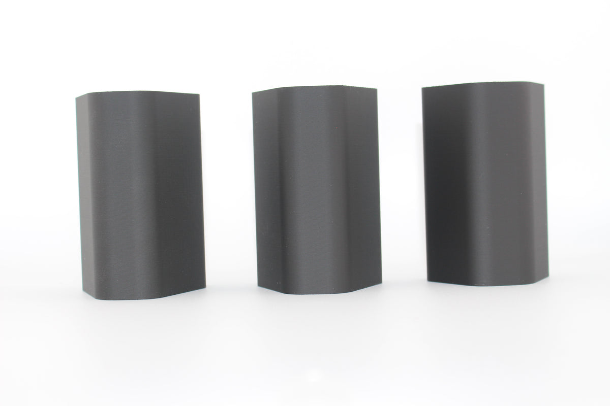 Top surfaces of three black half-size SBA3 cheek riser inserts representing 20mm, 17mm and 10mm heights, displayed upright with smooth, curved surfaces on a white background.