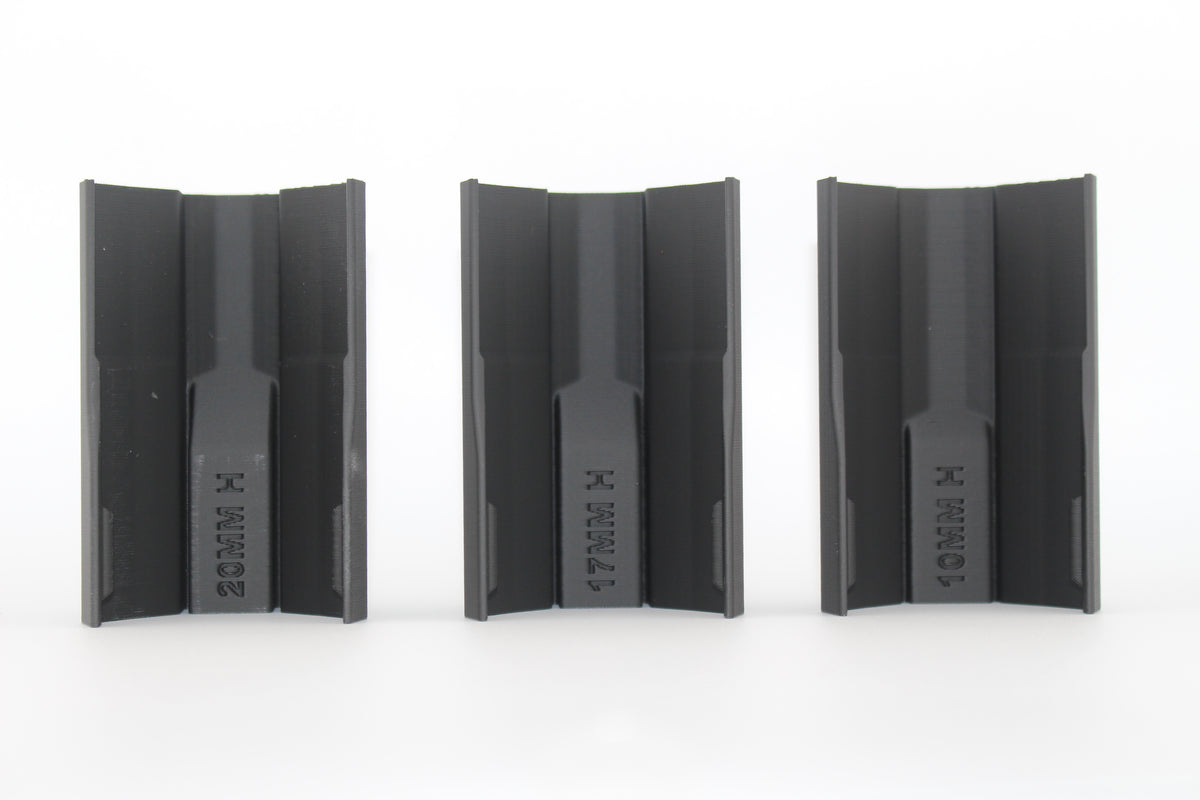 Bottom view of three black half-size SBA3 cheek riser inserts labeled 20mm, 17mm and 10mm, showing underside profiles and mounting channels, displayed on a white background.