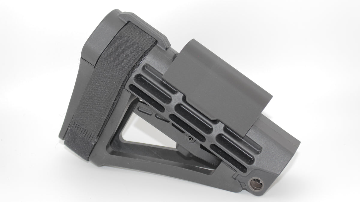 Side view of SBA4 modular cheek riser installed in the middle mounting position on the SBA4 brace, featuring black riser with smooth top and skeletonized brace design, displayed on a light grey background.