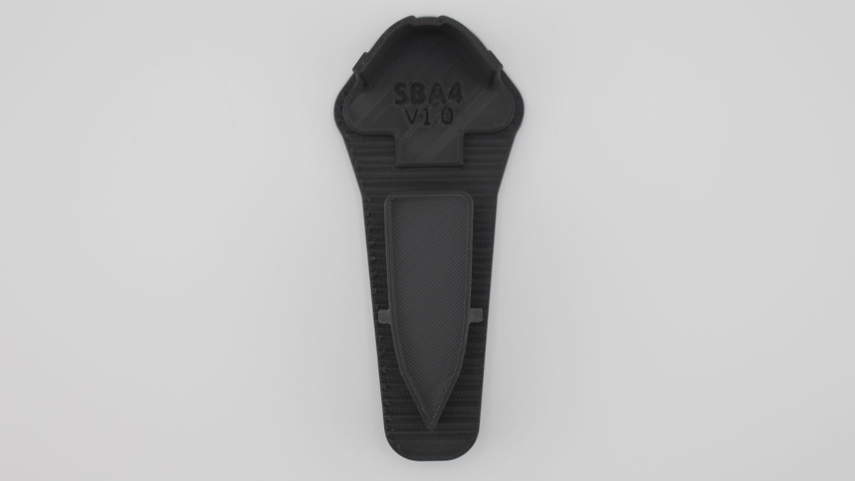 Top-down view of black SBA4 full-length Devoid plug showing tapered front wedge and rectangular recess with embossed "SBA4 V1.0" marking, displayed on a light grey background.